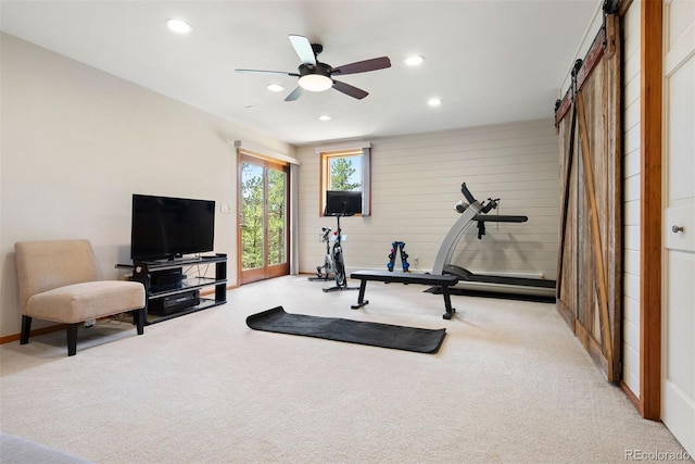2122 Cramner Ct, Evergreen, CO 80439 - workout area featuring recessed lighting, carpet flooring, a ceiling fan, a barn door, and wood walls