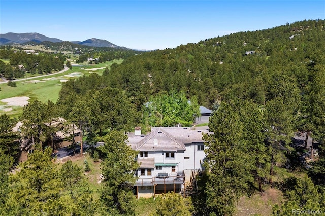 2122 Cramner Ct, Evergreen, CO 80439 - view from above of property featuring a mountain backdrop, a heavily wooded area, and a golf course
