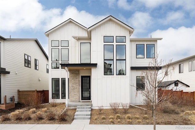 view of front of home with fence and board and batten siding