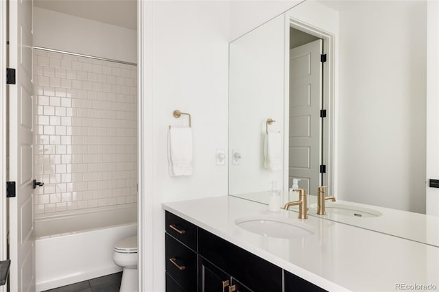 bathroom with toilet, tile patterned flooring,  shower combination, and vanity