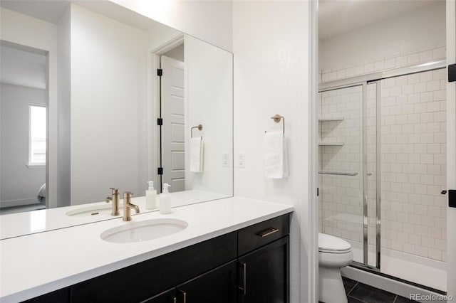 full bath with toilet, a shower stall, tile patterned flooring, and vanity