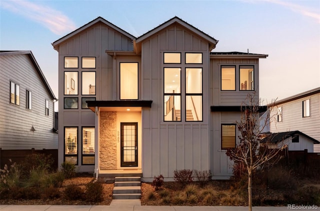 view of front of house featuring board and batten siding and stone siding