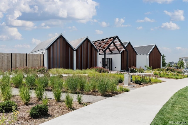 exterior space featuring a pole building, an outdoor structure, and fence