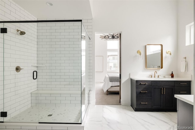 bathroom with marble finish floor, a shower stall, connected bathroom, and vanity