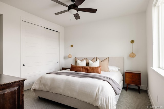 bedroom with ceiling fan, a closet, carpet, and baseboards