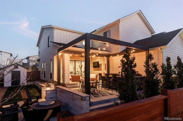 rear view of property featuring a patio and fence