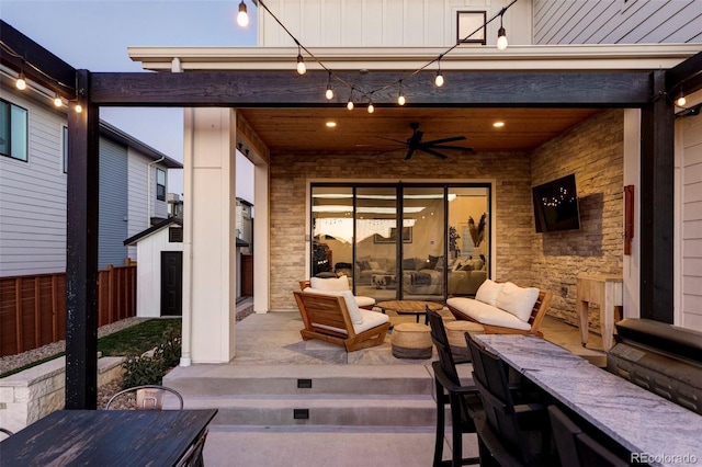 view of patio featuring fence, an outdoor living space, a ceiling fan, and outdoor dining space