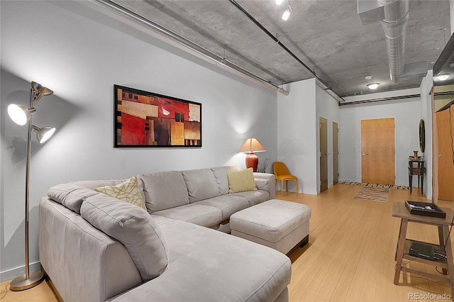 living room featuring light wood-type flooring and baseboards