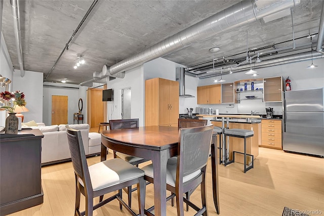 dining space with light wood-type flooring