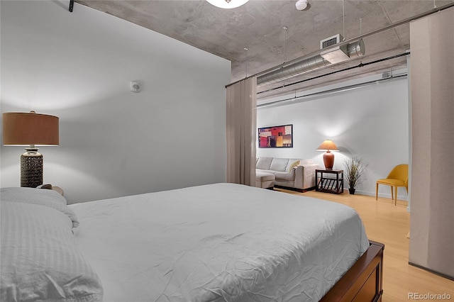 bedroom with visible vents and light wood finished floors
