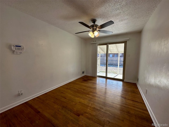 unfurnished room featuring a textured ceiling, ceiling fan, and dark wood-type flooring