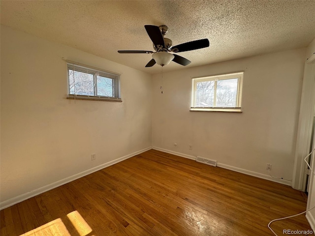 unfurnished room featuring ceiling fan, a textured ceiling, and hardwood / wood-style flooring