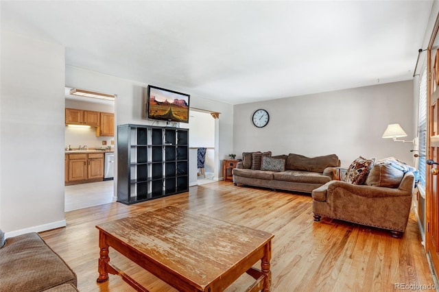 9040 Raleigh St, Westminster, CO 80031 - living room featuring light wood-type flooring and baseboards