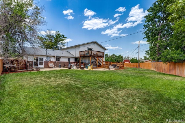 9040 Raleigh St, Westminster, CO 80031 - back of property with a wooden deck, stairway, a fenced backyard, and a patio area