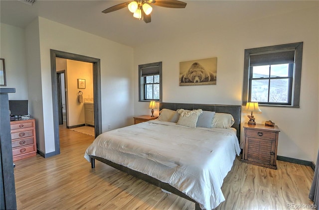 bedroom with light wood-style flooring, a ceiling fan, and baseboards