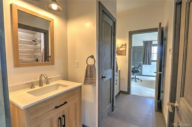 bathroom featuring baseboards, vanity, and tile patterned floors
