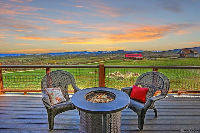 deck at dusk featuring a mountain view