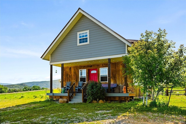 view of front of property with a mountain view and covered porch