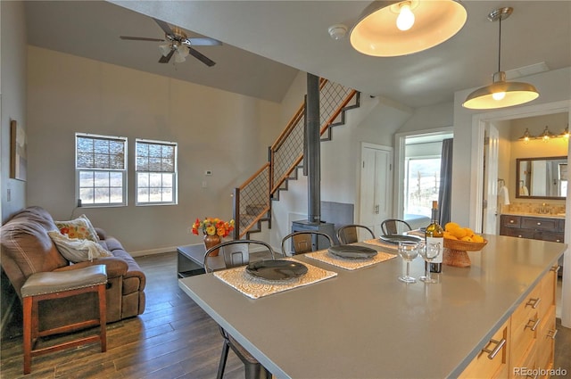 dining room featuring ceiling fan, stairs, and dark wood-style floors