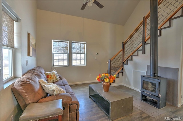 living room featuring high vaulted ceiling, a ceiling fan, and wood finished floors