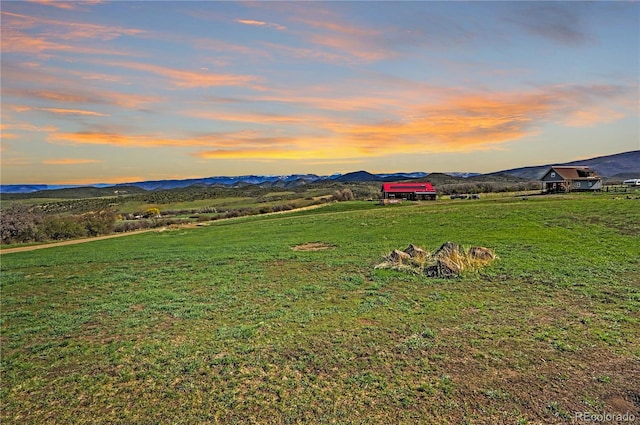 view of yard featuring a mountain view and a rural view