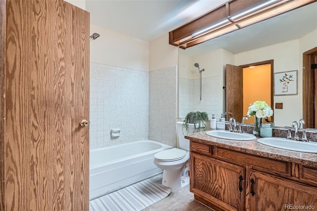 full bathroom featuring a sink, double vanity, toilet, and bathtub / shower combination