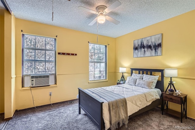 bedroom featuring carpet, cooling unit, a ceiling fan, and a textured ceiling