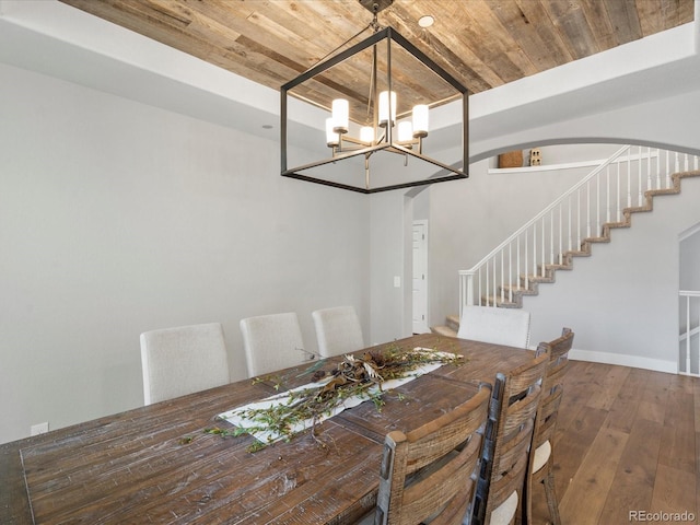 dining space with wooden ceiling, a chandelier, stairway, hardwood / wood-style floors, and arched walkways