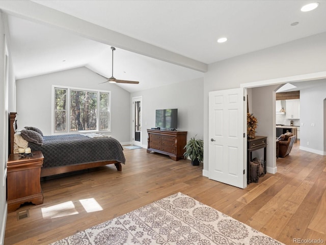 bedroom featuring light wood-style floors, lofted ceiling, a ceiling fan, baseboards, and arched walkways
