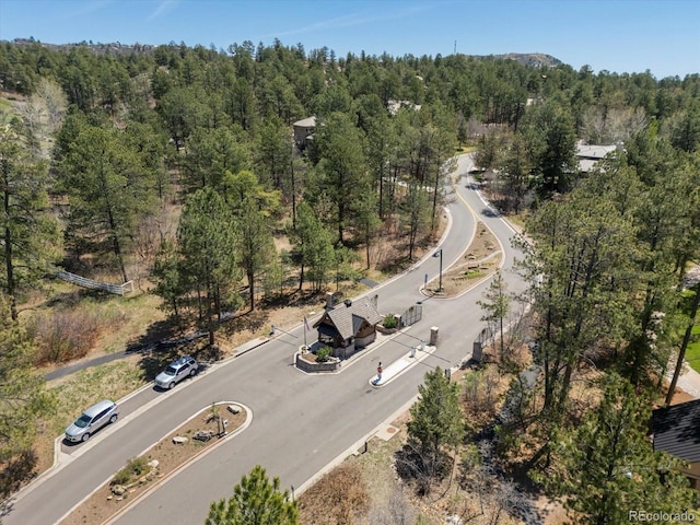 aerial view of property's location featuring a heavily wooded area