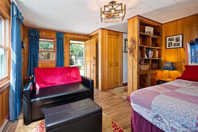 115 Lions Gate Dr, Winter Park, CO 80482 - bedroom featuring wooden walls, a notable chandelier, and wood finished floors