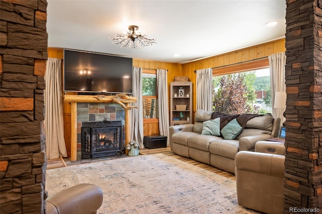 115 Lions Gate Dr, Winter Park, CO 80482 - living room with a chandelier, wood finished floors, wood walls, and a fireplace