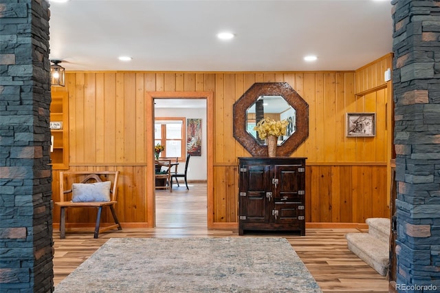 115 Lions Gate Dr, Winter Park, CO 80482 - living area featuring ornate columns, recessed lighting, wood finished floors, wood walls, and stairs