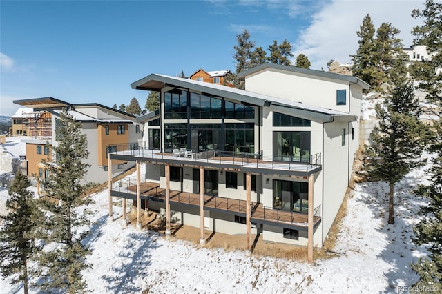 view of snow covered rear of property