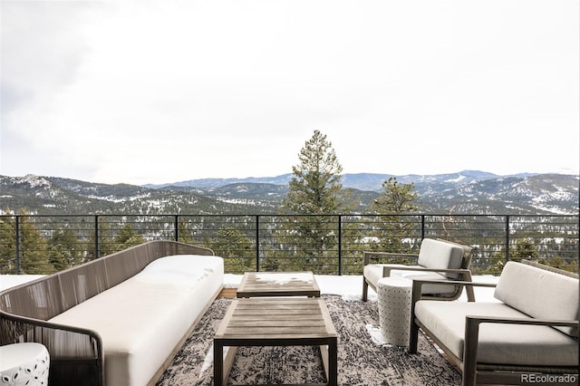 balcony featuring a mountain view and an outdoor living space