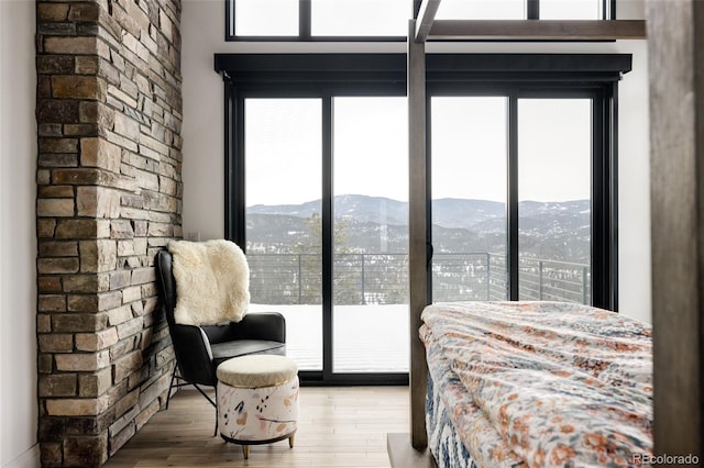 bedroom with a mountain view, access to exterior, and hardwood / wood-style floors