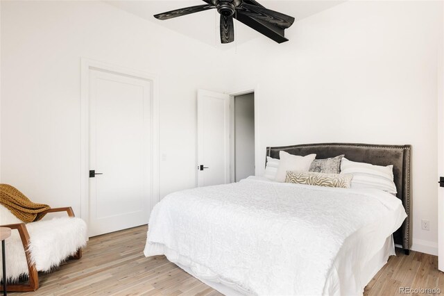 bedroom with light wood-type flooring and ceiling fan