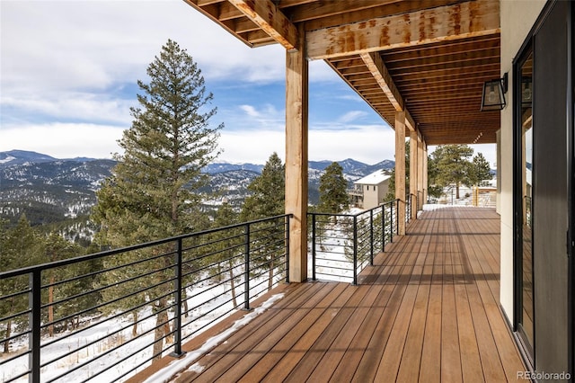 snow covered deck featuring a mountain view