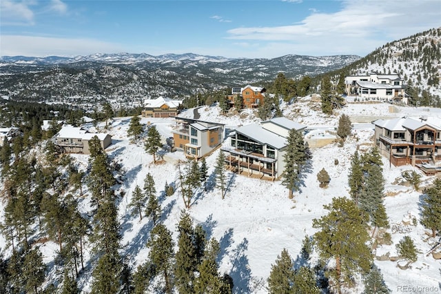 snowy aerial view featuring a mountain view