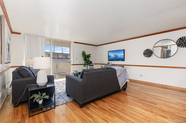 living room with hardwood / wood-style flooring and ornamental molding