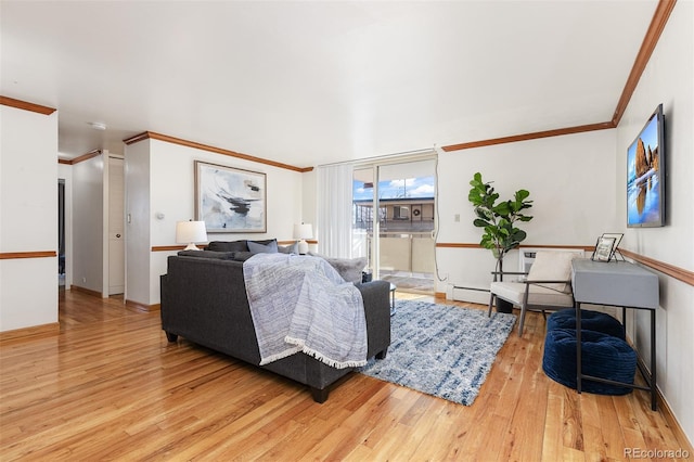 living room with light hardwood / wood-style floors, baseboard heating, and crown molding