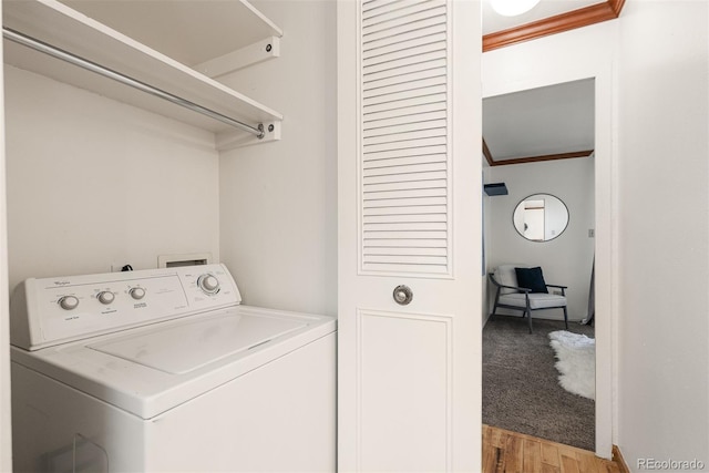 laundry room featuring washer / clothes dryer, ornamental molding, and light hardwood / wood-style floors