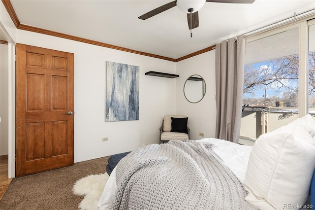 carpeted bedroom featuring ceiling fan and crown molding