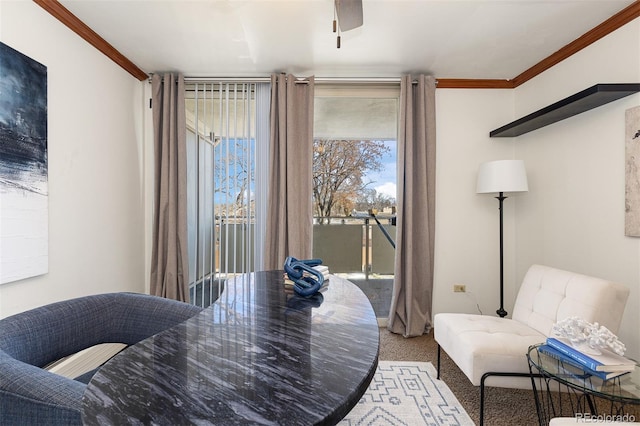 dining room featuring carpet, ceiling fan, and crown molding