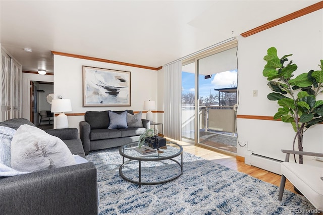 living room featuring ornamental molding, a baseboard heating unit, and light wood-type flooring