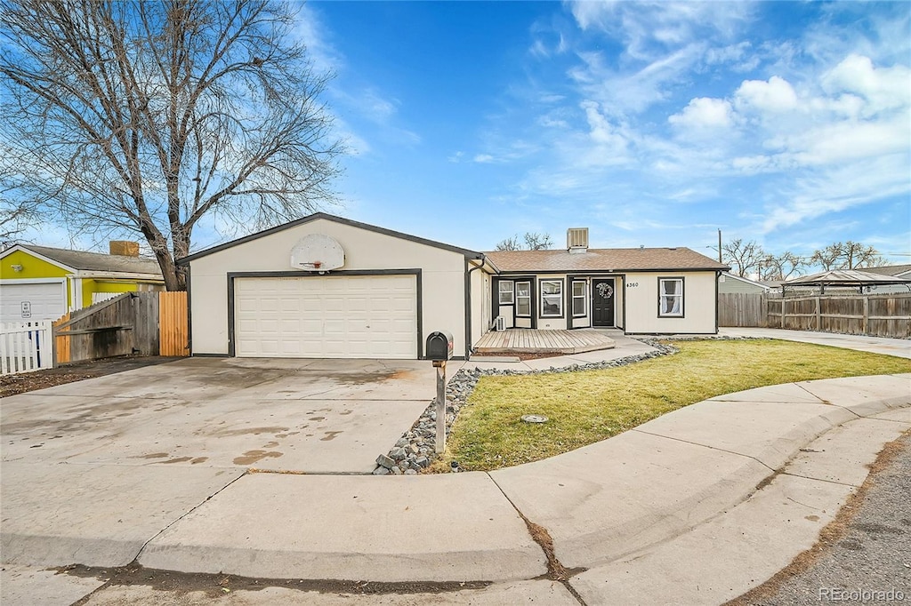 ranch-style house with a front yard and a garage