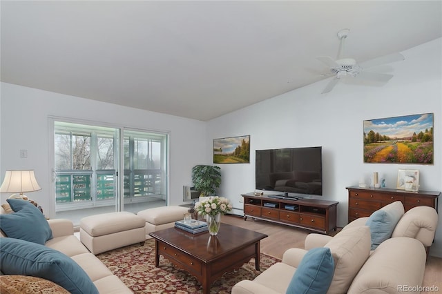 living room with wood finished floors, lofted ceiling, a baseboard radiator, and ceiling fan