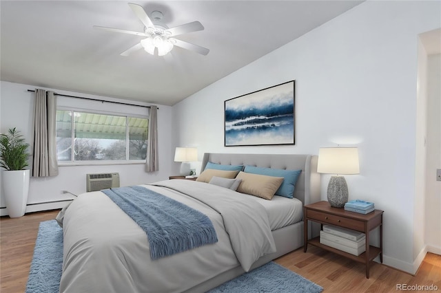 bedroom featuring an AC wall unit, wood finished floors, vaulted ceiling, ceiling fan, and baseboards