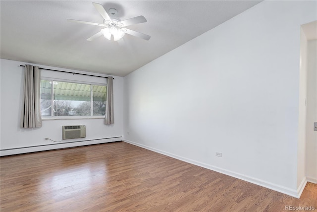 empty room with a baseboard heating unit, wood finished floors, baseboards, a wall mounted AC, and ceiling fan