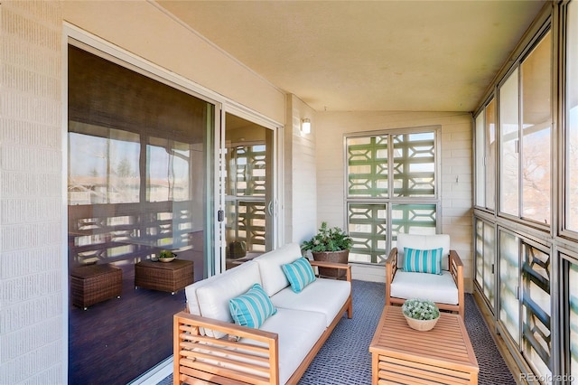 sunroom / solarium featuring outdoor lounge area and lofted ceiling